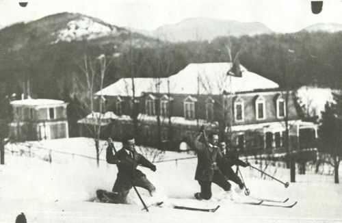 Photograph of Skiers demonstrate telemark turn techniques in Lake Placid