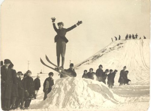 Young skier going off a snow jump in 1918 in Côte-des-Glacis, Québec