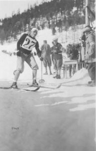 W.B. Thompson crosses finish line of 18km cross country skiing event at 1928 St. Moritz Olympic Winter Games