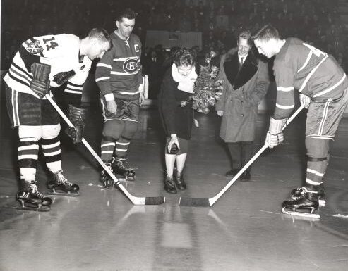 Montreal Forum (Chicago Blackhawks vs Montreal Canadians) - Ceremonial faceoff by Lucile Wheeler, with Maurice 'Rocket' Richard and Pepi Salvenmoser. Jean Béliveau is #4.
