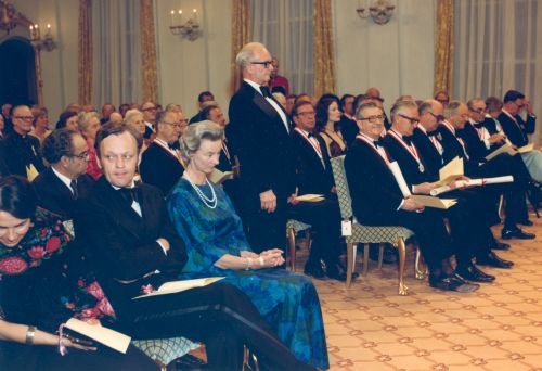 Dr. Douglas Firth (standing) becoming a member of the Order of Canada in 1976.