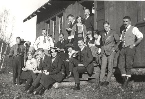 Group of people on steps of first lodge on the knoll built by Ottawa Ski Club, 1921-22.