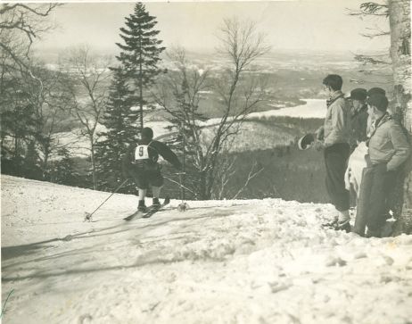 c.1936. Quebec-Kandahar, skier wearing #9 taking off third pitch at top.