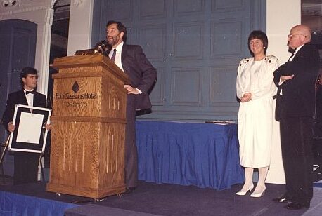 Inductee Al Raine (podium) with Nancy Greene 