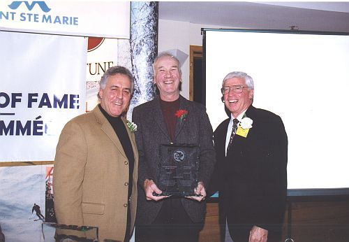 [L to R]: Master of Ceremonies, Peter Duncan, with Inductee Bob Gilmour and Canadian Ski Museum Chair, Arnold Midgley, at 2003 Canadian Ski Hall of Fame Induction Ceremony